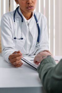 hands of doctor and patient on table