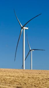 wind turbines on hill against clear sky
