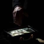 StockCake-Hand_reaches_money-1210870-medium