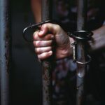 StockCake-Handcuffed_Behind_Bars-658730-medium